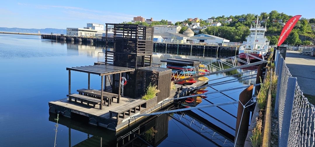 Foto av badebrygge med benker og tårn ved Strandveikaia