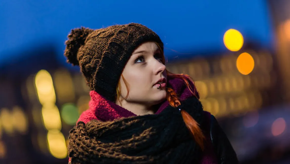 Photo of young woman looking to her side.