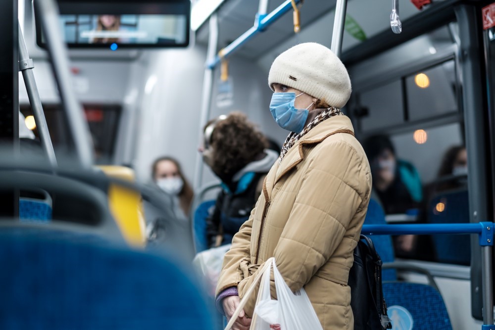 Lady with face mask on the bus.